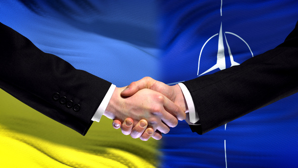 Ukraine and NATO handshake, international friendship relations, flag background - Photo, Image