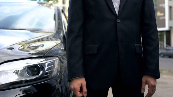 Personal driver standing near business class car waiting for vip passenger - Foto, Imagen