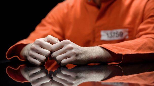 Arrested person hands closeup, prisoner talking to lawyer during interrogation - Фото, зображення