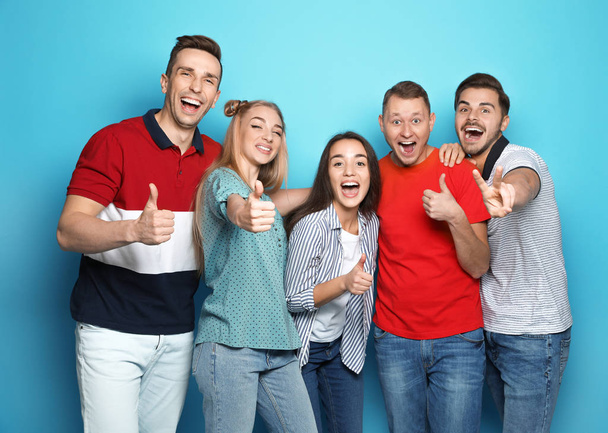 Group of friends celebrating victory against color background - Фото, зображення