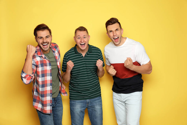 Group of friends laughing together against color background - Photo, Image