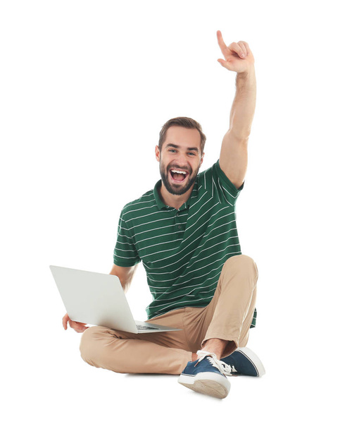 Emotional young man with laptop celebrating victory on white background - Foto, Imagen