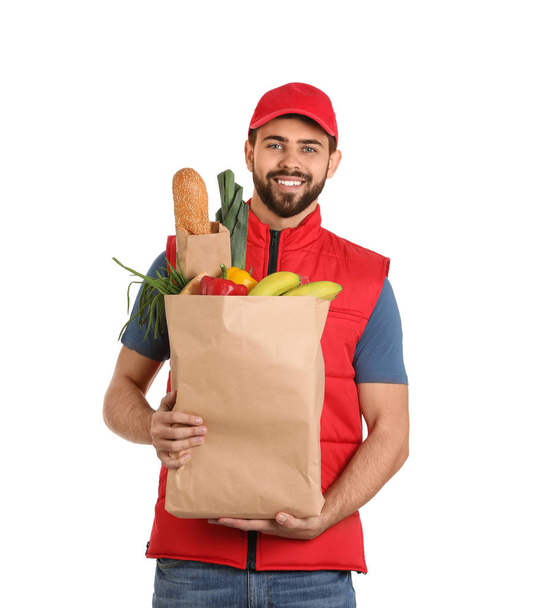 Man holding paper bag with fresh products on white background. Food delivery service - Foto, afbeelding