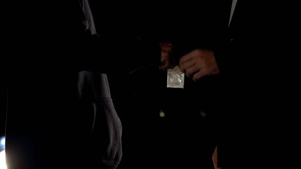 Male in business suit taking cocaine package, illegal drug trade, addiction - Φωτογραφία, εικόνα