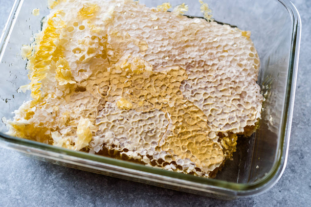 Fresh Honeycomb Pieces with Honey in Glass Bowl. Organic Food. - 写真・画像