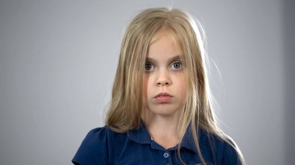 Portrait of scared schoolgirl, kid searching for parents, child custody adoption - Valokuva, kuva