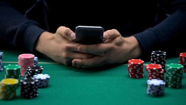 Young person playing gambling games on mobile phone app, casino web site - Zdjęcie, obraz