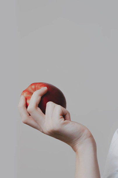 White young woman's hand is holding red apple.. Fruits, diets and healthy food - Foto, Bild