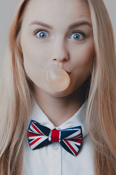 Young playful cute blonde inflates bubble of gum. Emotions and lifestyle - Foto, immagini