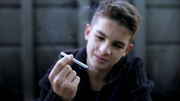 Bad company and street influence, boy smoking cigarette, childrens protest - Foto, Imagem