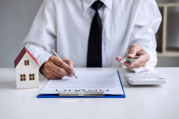 Real estate agent Sales manager holding filing keys to customer after signing rental lease contract of sale purchase agreement, concerning mortgage loan offer for and house insurance. - 写真・画像