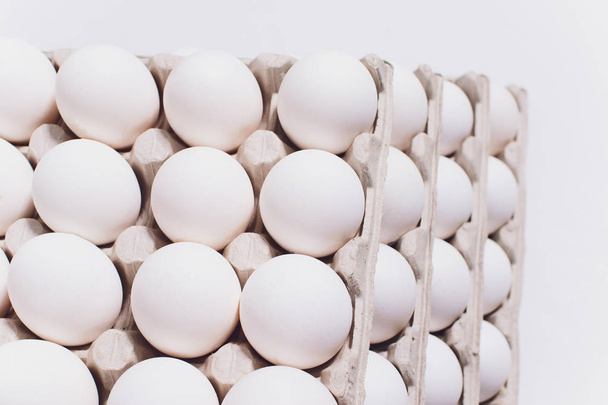 White eggs of a hen in harmless, cardboard packing on a white background. 5 packs. - Foto, Imagem
