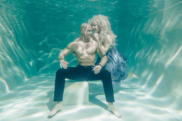 beautiful romantic couple of lovers hugging gently under water - Photo, Image