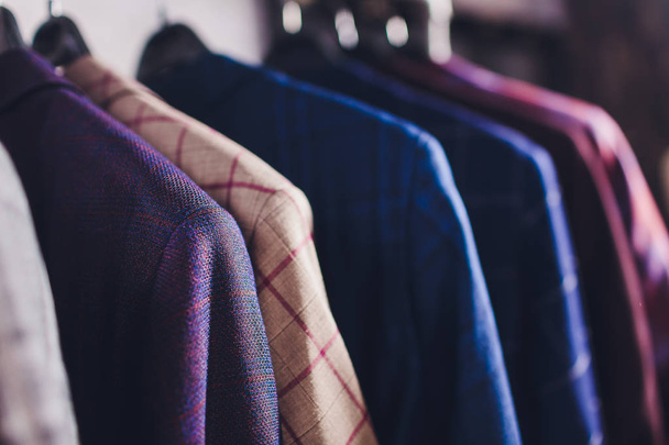 workpiece jackets on clothes hanger in tailoring studio. - Фото, зображення