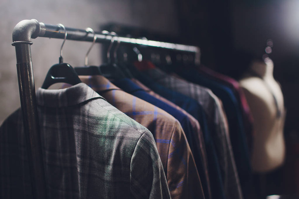 workpiece jackets on clothes hanger in tailoring studio. - Fotó, kép