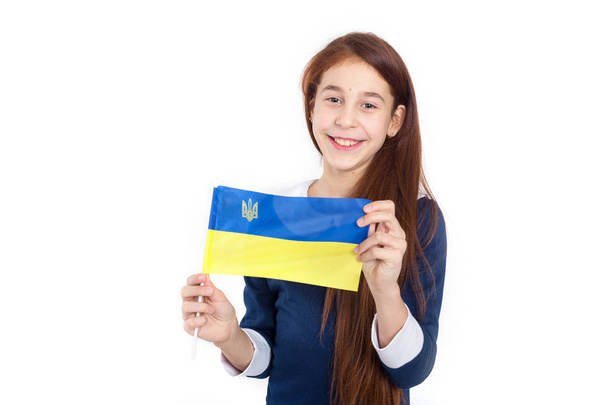 Beautiful girl with the flag of Ukraine on a white background. Learn Ukrainian language. - Zdjęcie, obraz