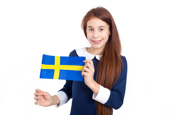 Beautiful girl with the flag of Sweden on a light background. Learn Swedish. - Φωτογραφία, εικόνα