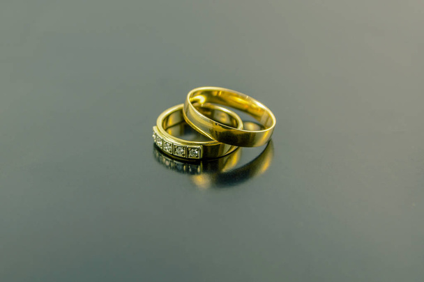 two wedding rings isolated on dark background - Fotó, kép
