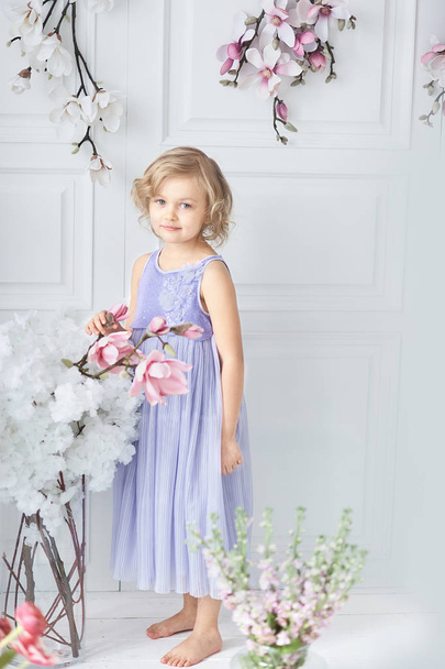 little girl with a bouquet of spring flowers. little cute holding bouquet as present for mother father day. - Photo, image