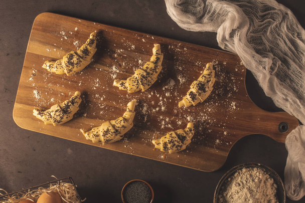 Raw croissant with ingredients on a kitchen countertop. - Zdjęcie, obraz