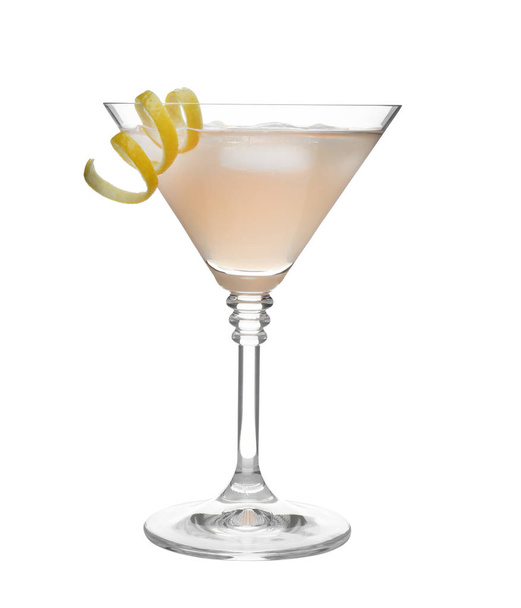 Glass of martini cocktail with ice cubes and lemon zest on white background - Photo, image