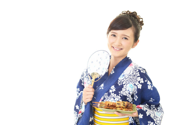Attractive young woman wearing Japanese summer kimono - Photo, image