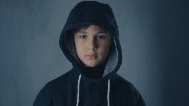 Portrait of a homeless orphan boy in a hood - Footage, Video