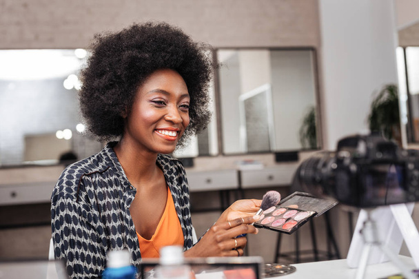 Cute dark-skinned woman with coral lipstick conducting online tutorial - Valokuva, kuva