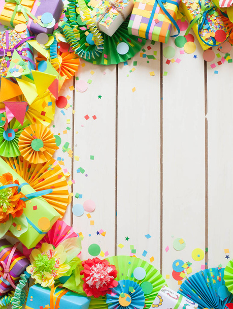 Colored flags garlands and gifts on wooden background  - 写真・画像