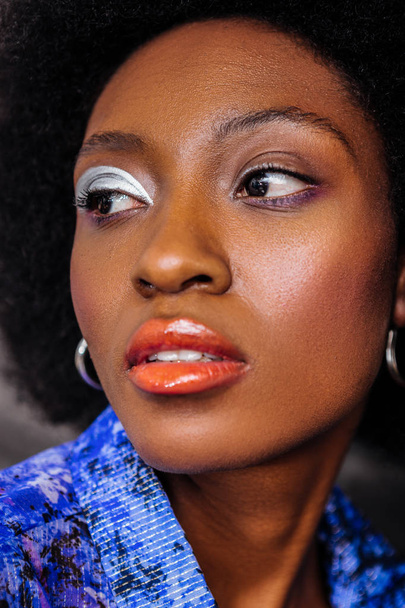 Dark-skinned african american model with big earrings looking serious - Photo, image