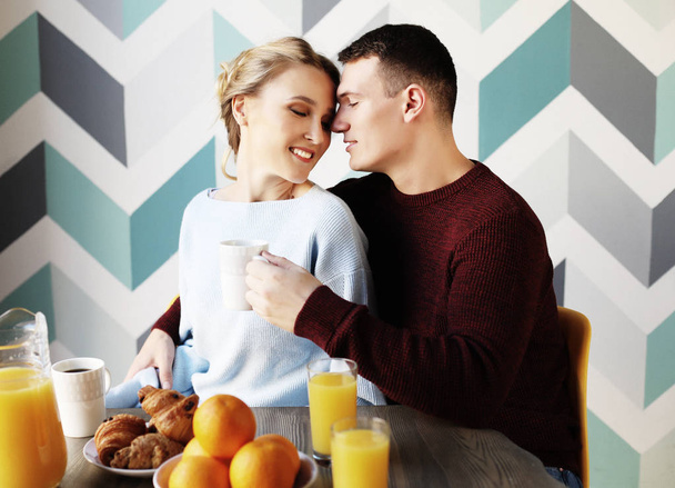 young beautiful couple having breakfast table - Photo, image