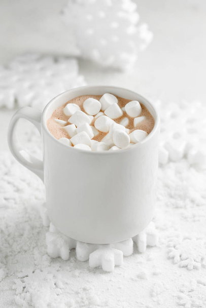 cocoa with marshmallows on a winter background with snowflakes - Foto, imagen
