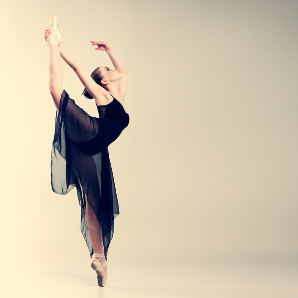 Beautiful ballet-dancer, modern style dancer posing on studio background - Fotó, kép