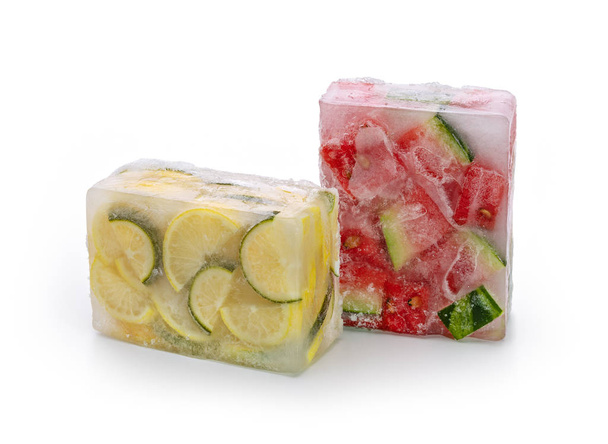 Frozen food concept: red watermelon slices, lemon and lime slices were frozen inside ice cubes. - Fotografie, Obrázek