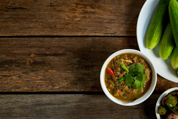 Thai food, Fermented fish spicy dip on wood, dark food photography - Photo, Image