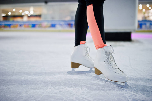 Legs of ice skater on the ice rink. - Valokuva, kuva