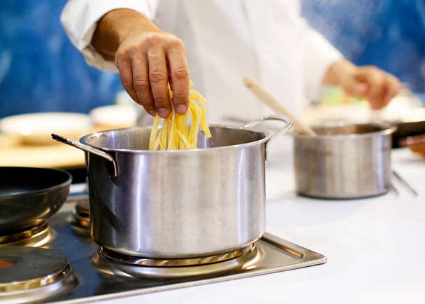 шеф кухар готує спагетті на кухні
 - Фото, зображення