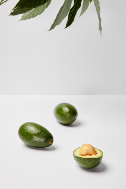 selective focus of avocados on grey background - Zdjęcie, obraz