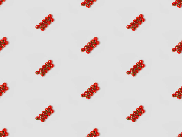  collage of cherry tomatoes on grey background, seamless background pattern - Foto, Imagen
