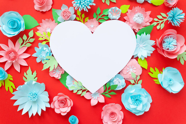 Heart frame with paper flowers with green leaves on red background. Cut from paper. Valentines day concept - Photo, Image