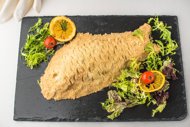 Fish baked in dough on slate with vegetables - Fotoğraf, Görsel