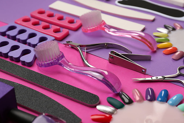 Set of professional tools for pedicure on color background - Foto, afbeelding