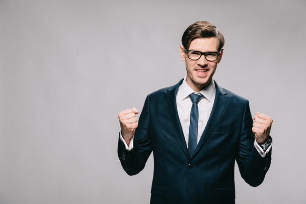 excited businessman celebrating victory isolated on grey - Foto, immagini