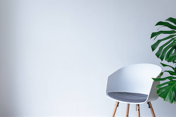 Modern chair near light wall - Foto, Imagen