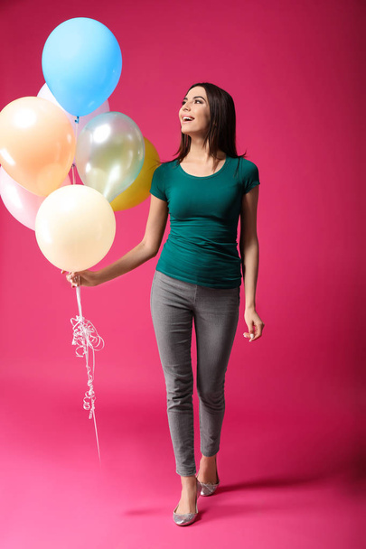 Beautiful young woman with balloons on color background - Foto, immagini