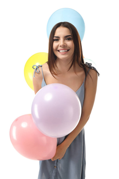 Bella giovane donna con palloncini su sfondo bianco - Foto, immagini
