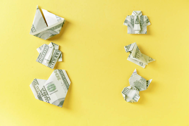 Different origami figures made of dollar banknotes on color background - Φωτογραφία, εικόνα