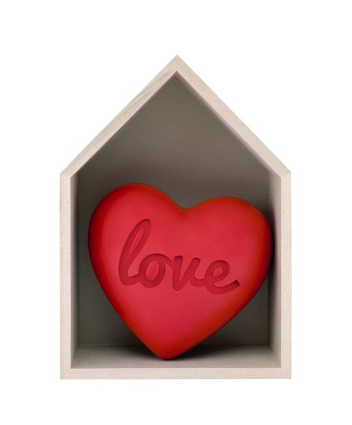 Wooden house and red heart with imprinted word love isolated on white with clipping path  - Фото, изображение