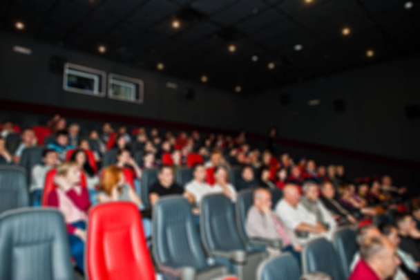 Blured photo of audience peoples in the cinema. - Zdjęcie, obraz