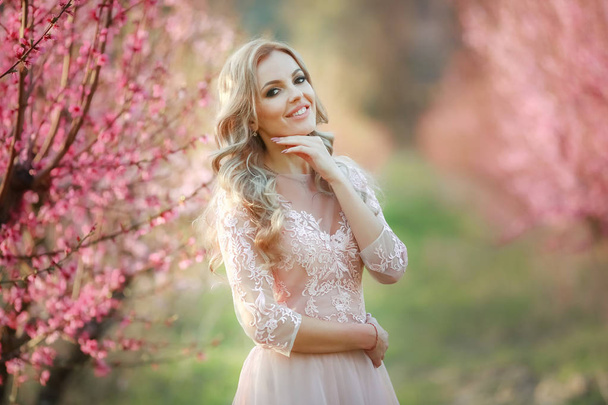 Portrait of blonde in the garden. makeup, Airy dress - Photo, Image